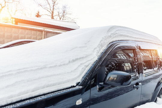 City Street Driveway Parking Lot Spot With Small Car Covered Snow Stuck Trapped After Heavy Blizzard Snowfall Winter Day By Big Snowy Pile. Snowdrifts And Freezed Vehicles. Extreme Weather Conditions