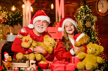 Fototapeta na wymiar Enjoying this day. father and daughter love christmas. happy new year. grandfather and grandchild at home. xmas happiness and joy. gift for child. family holiday weekend. small girl with santa man