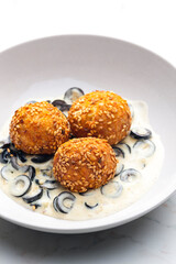 chickpeas balls with creamy black olives sauce