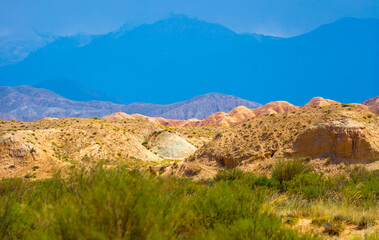 Natural unusual landscape of red rocks against the backdrop of blue mountains. The extraordinary beauty of nature is similar to the Martian landscape. Amazingly beautiful landscape.
