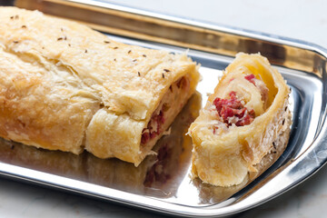 crispy pastry filled with smoked meat and sour cabbage