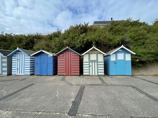 Fototapeta na wymiar Beach huts on the seafront painted bright colours. Taken in Lowestoft England. 