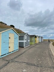 Fototapeta na wymiar Beach huts on the seafront painted bright colours. Taken in Lowestoft England. 