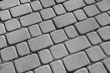 Abstract background of old cobblestone pavement close-up.