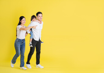 happy asian family image, isolated on yellow background