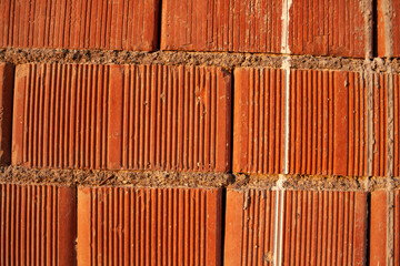 Red ceramic bricks close up. Keramoblock. Red brick wall texture background