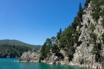 View of the lake with clear turquoise water and on the mountain cliffs of the Green Canyon. Manavgat, Antalya, Turkey