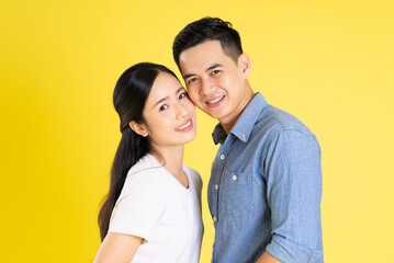 image of asian couple posing on yellow background