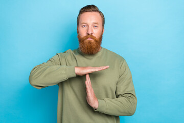Photo of attractive serious man two arm make symbol warning time up finish work isolated on blue color background