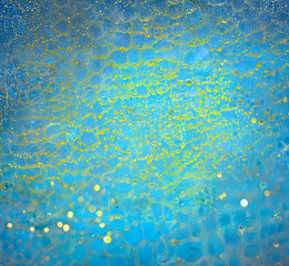 Abstract texture of blue and yellow background with water droplet. Macro photography of blue translucent organic matter.