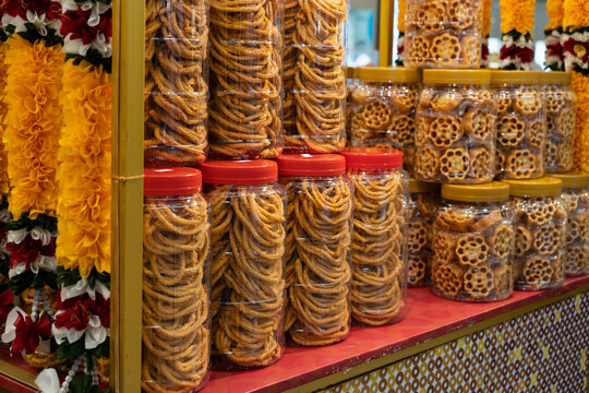 Close-up view of the honeycomb cookies and muruku cookies selling at the booth.