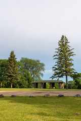 Fototapeta na wymiar Shelter made of stones with a wooden roof at Roosevelt Park in Fergus Falls, Minnesota USA 
