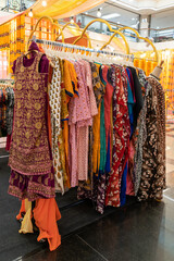 Various types of Indian fashion clothes displaying and selling in the shopping mall.