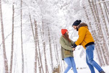 Couple spending snowy winter day outdoors while on winter vacation