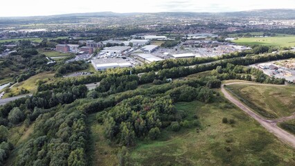 Aerial view of an industrial factory surrounded by green fields and trees. Taken in Bury Lancashire. 