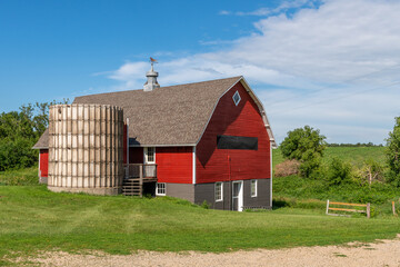 Red barn with brown shingled roof and  old silo on a farm in rural Minnesota, USA.  © Barbara