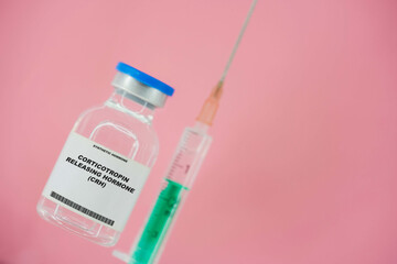 Corticotropin releasing hormone (CRH). Test tube with artificial hormone on pink background Corticotropin releasing hormone (CRH)