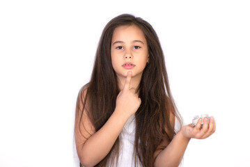 Fototapeta premium Happy child presenting beauty cosmetic product of facial skin cream