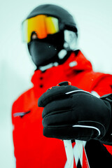 hands in gloves. 
Skier in the winter in the mountains