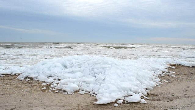 Ice blocks on a beach. Ice and wave