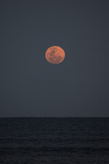 Full moon rising over the atlantic ocean