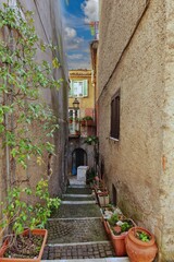 A narrow street between the old stone houses of Collepardo, a medieval village in the Lazio region of Italy.