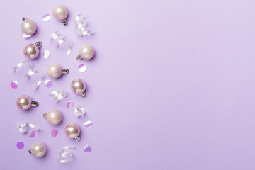Christmas balls on color background, top view