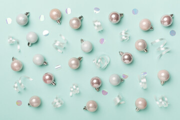 Christmas balls on color background, top view