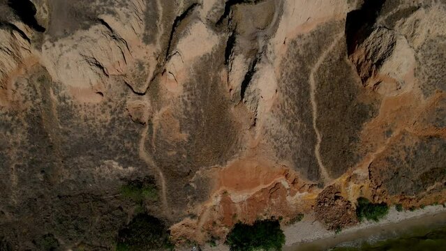 aerial amazing texture of Abstract relief shapes of sandy hills from bird's eye view. Location canyon Stanislav, Dnipro Bay, Ukraine. Cinematic drone shot. Filmed in UHD 4k video. Discover beauty of