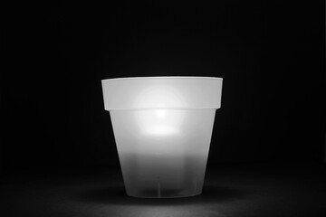 concept energy cuts, DIY lamp, pot and candle indoors, on the desk, background black and white.