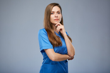 Serious nurse woman in blue medical uniform. Isolated female portrait.