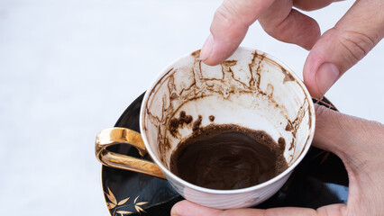 Fortune telling with coffee. Woman fortune teller predicting the future with coffee grounds