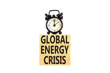 Global energy crisis symbol. Concept words Global energy crisis on wooden blocks. Black alarm clock. Beautiful white table white background. Business and global energy crisis concept. Copy space.