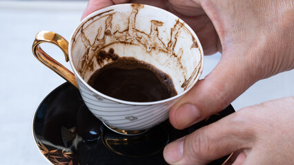Fortune telling with coffee. Woman fortune teller predicting the future with coffee grounds