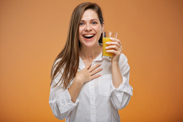 Woman holding orange juice. Isolated female advertising portrait.