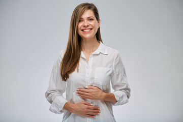 Happy healthy woman holding hands on belly. isolated portrait on white.