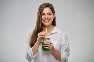 Smiling woman holding glass with green smoothie. Isolated female advertising portrait.