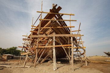 MANDVI, GUJARAT, INDIA: authentic dhow (traditional wooden boat carrying freight across the Arabian Sea) under construction