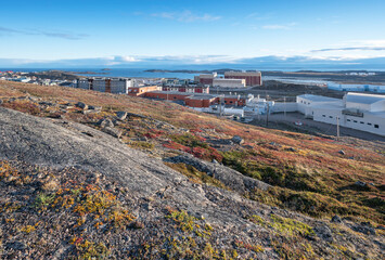 Overview of the city of Iqaluit with the Arctic Ocean harbor in the distance
