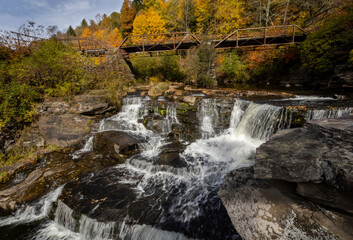 Tanners Falls in the Poconos near Honesdale, PA, on a brilliant fall day, which features multiple cascades and a historic bridge 