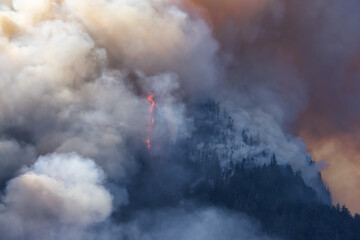 BC Forest Fire and Smoke over the mountain near Hope during a hot sunny summer day. British Columbia, Canada. Wildfire natural disaster