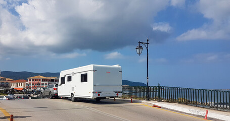 caravan car trailer travelling on the road in an autumn sunny day