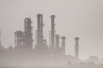 Fototapeta na wymiar Oil refinery in the middle of smog