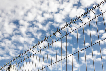 metal grid on blue sky background