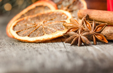 anise, dried oranges and cinnamon on a wooden table, spices for drinks