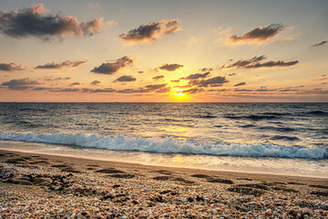 beautiful sunset at the sea on a cloudy evening golden hour