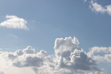 Naklejka na ściany i meble Powerfully cumulus white clouds against a blue sky.