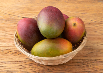 A group of ripe mangos over wooden table