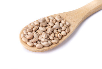 Brown beans on a spoon isolated over white background