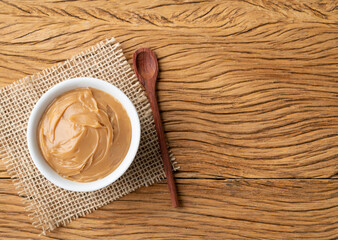 Doce de leite, traditional brazilian creamy milk sweet over wooden table with copy space